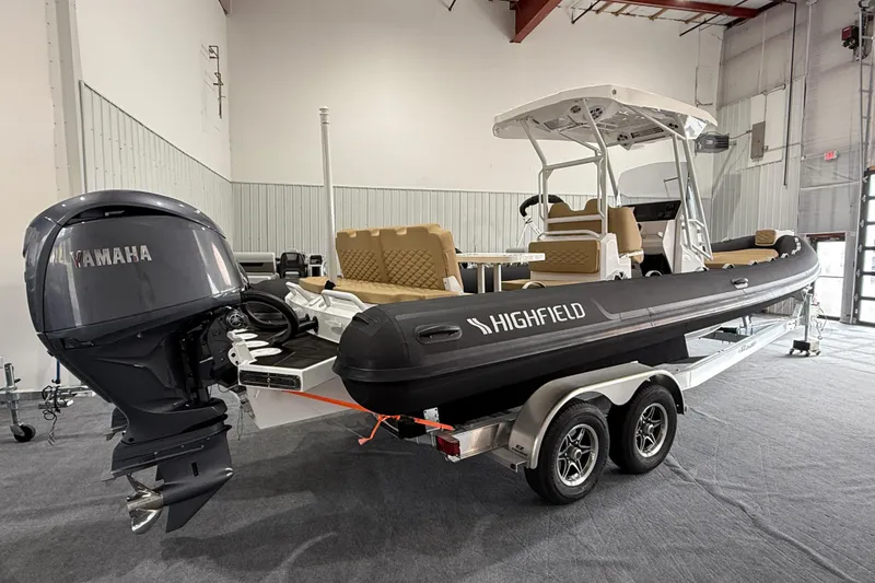 Slide: The Image of 2026 Highfield Sport 800 boat with Yamaha engine on a trailer in a showroom. - 2