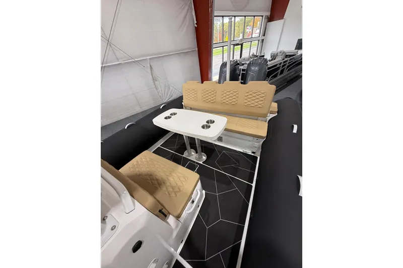 Slide: The Image of 2026 Highfield Sport 800 boat interior with beige seating and a white table. - 20