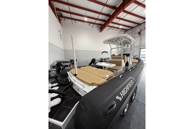 Slide: The Image of 2026 Highfield Sport 800 boat in showroom, featuring sleek design and comfortable seating. - 25