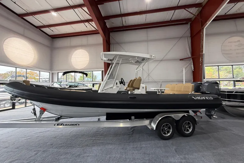 Slide: The Image of 2026 Highfield Sport 800 boat on trailer in showroom, featuring sleek design and modern amenities. - 3