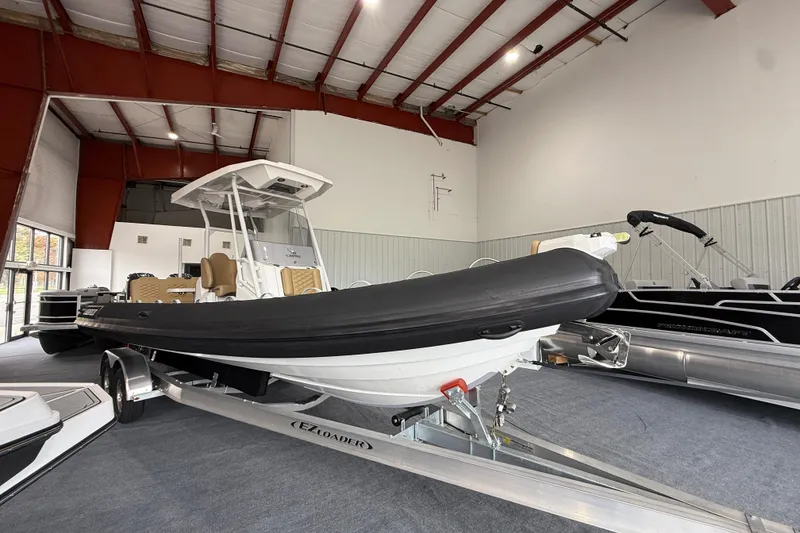 Slide: The Image of 2026 Highfield Sport 800 boat on trailer in indoor showroom. - 5