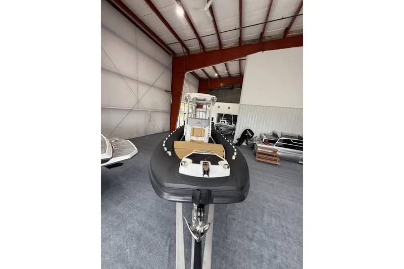 Slide: The Image of 2026 Highfield Sport 800 boat displayed in a spacious indoor showroom. - 9