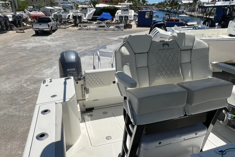 Slide: The Image of 2024 World Cat 260 CC-X boat interior with seating and engine view. - 11