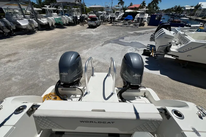 Slide: The Image of 2024 World Cat 260 CC-X boat with twin 200 horsepower engines in a marina setting. - 12