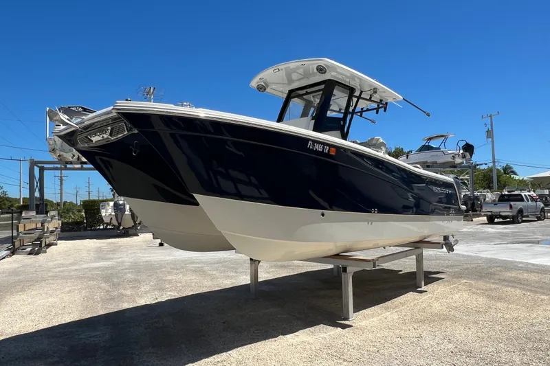 Slide: The Image of 2024 World Cat 260 CC-X boat on display under clear blue sky. - 2