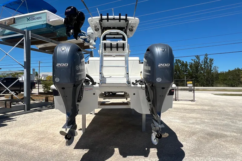 Slide: The Image of 2024 World Cat 260 CC-X boat with dual Yamaha 200 engines, parked outdoors. - 4