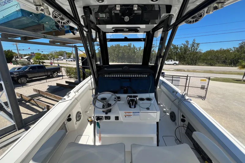 Slide: The Image of 2024 World Cat 260 CC-X boat interior with steering wheel and control panel. - 6