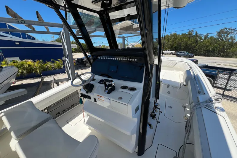 Slide: The Image of 2024 World Cat 260 CC-X boat interior with steering console and seating. - 8