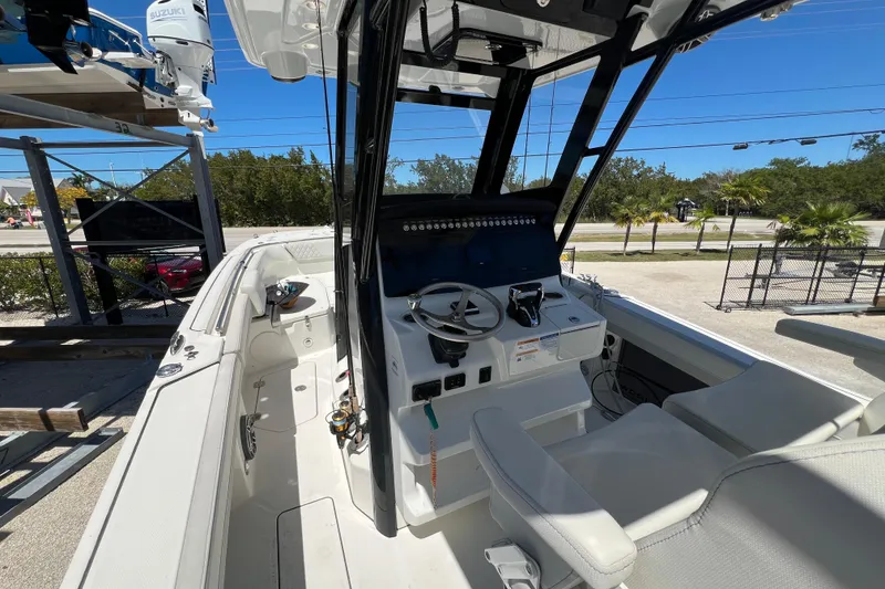 Slide: The Image of 2024 World Cat 260 CC-X boat interior with steering console and seating. - 9