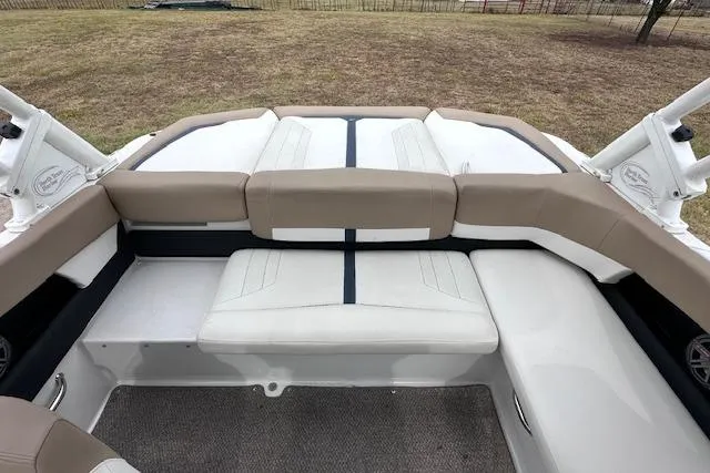 Slide: The Image of 2013 Four Winns H210SS boat interior with beige and white seating. - 13