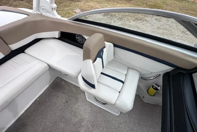 Slide: The Image of 2013 Four Winns H210SS boat interior with white and beige seating. - 14