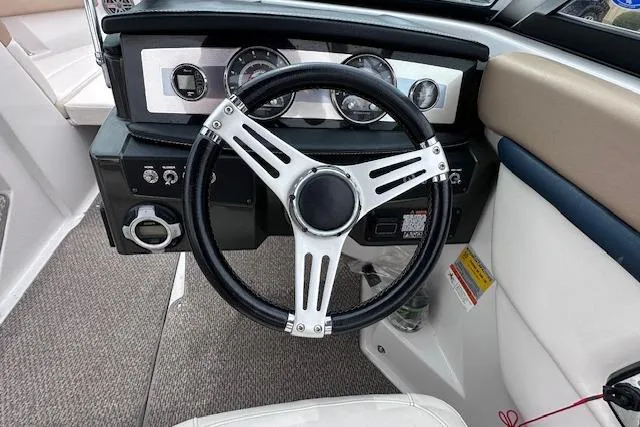 Slide: The Image of Steering wheel and dashboard of 2013 Four Winns H210SS boat. - 16