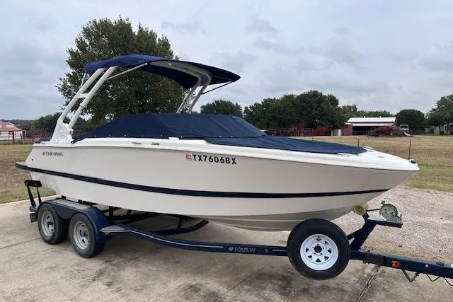Slide: The Image of 2013 Four Winns H210SS boat on trailer with blue cover and canopy. - 23