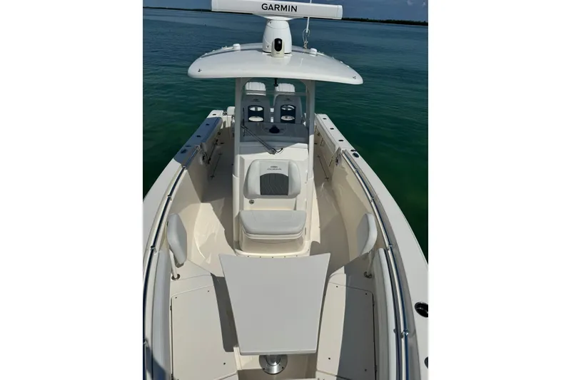 Slide: The Image of 2023 Cobia 280 Center Console boat on calm water, featuring a sleek design and modern equipment. - 11