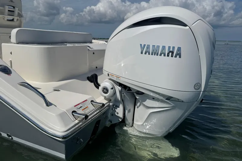 Slide: The Image of 2023 Cobia 280 Center Console with Yamaha outboard engine in shallow water. - 7