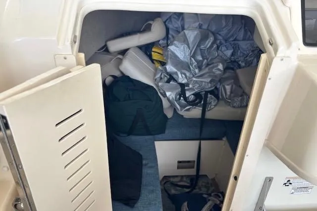 Slide: The Image of 2015 Grady-White Adventure 208 cabin interior with storage and gear. - 11