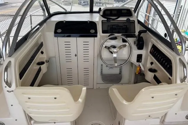 Slide: The Image of Interior of 2015 Grady-White Adventure 208 boat, featuring steering wheel and seating. - 6