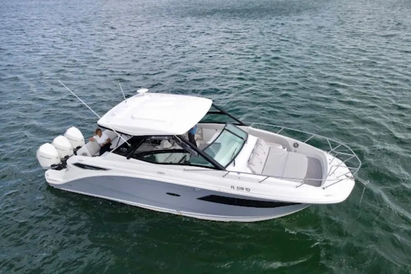 Slide: The Image of 2022 Sea Ray Sundancer 320 Outboard cruising on open water. - 11