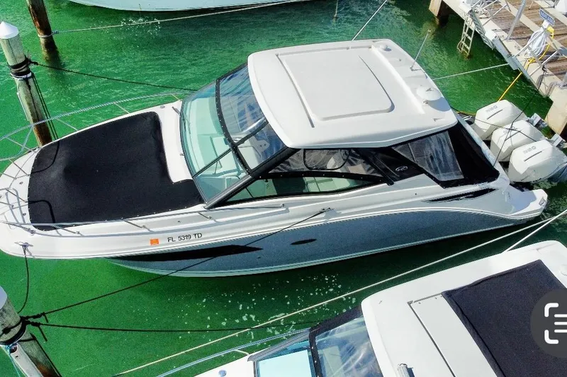 Slide: The Image of 2022 Sea Ray Sundancer 320 Outboard docked in clear green water. - 12