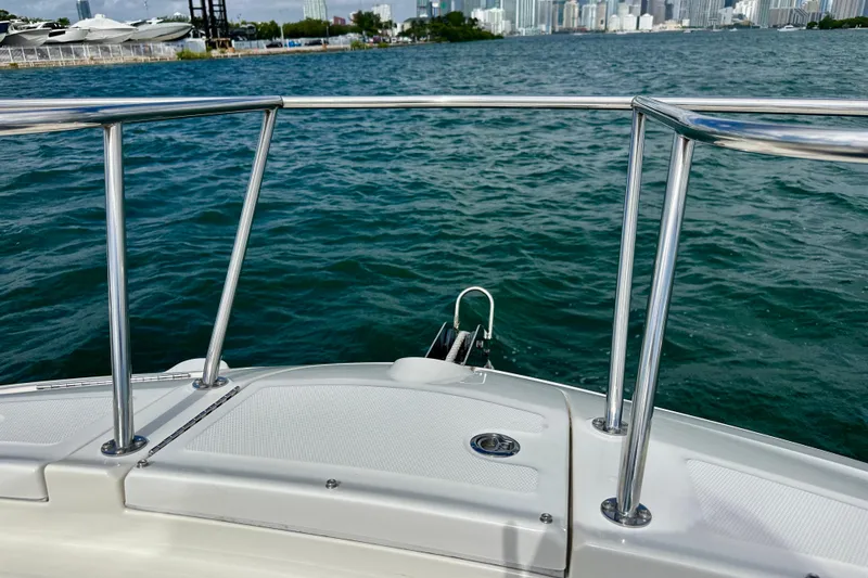 Slide: The Image of 2022 Sea Ray Sundancer 320 Outboard on water, city skyline in background. - 14