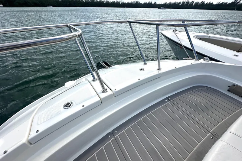 Slide: The Image of 2022 Sea Ray Sundancer 320 Outboard deck with railing, overlooking calm waters. - 16