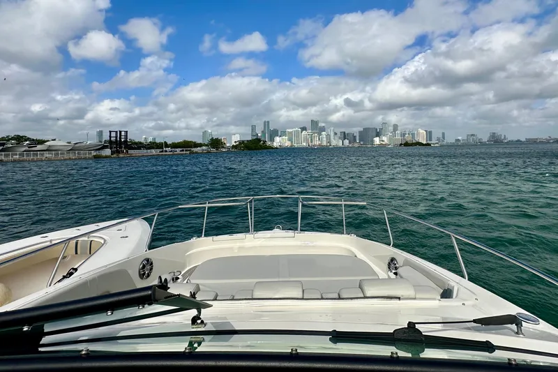 Slide: The Image of 2022 Sea Ray Sundancer 320 Outboard cruising with city skyline view. - 17