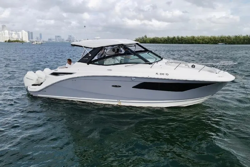 Slide: The Image of 2022 Sea Ray Sundancer 320 Outboard cruising on a calm, scenic waterway. - 2