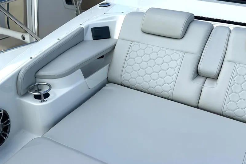 Slide: The Image of Luxurious seating on 2022 Sea Ray Sundancer 320 Outboard with hexagonal stitching and cup holder. - 22