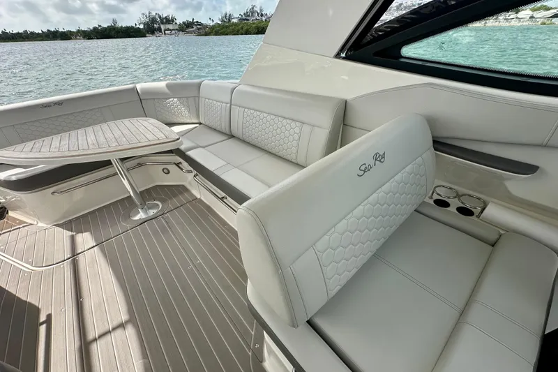 Slide: The Image of 2022 Sea Ray Sundancer 320 Outboard interior with elegant seating and table, overlooking water. - 28