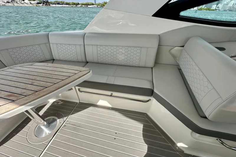 Slide: The Image of Luxurious seating area on 2022 Sea Ray Sundancer 320 Outboard yacht with elegant wood table. - 29