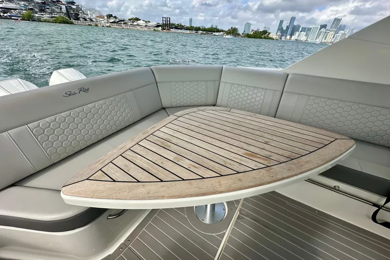 Slide: The Image of Luxurious 2022 Sea Ray Sundancer 320 Outboard boat interior with elegant seating and wooden table. - 31