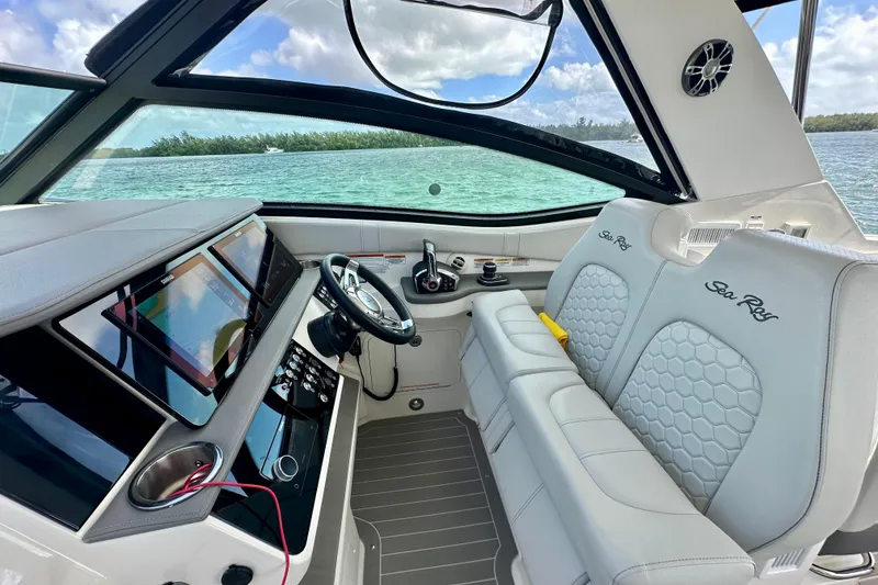 Slide: The Image of 2022 Sea Ray Sundancer 320 Outboard cockpit with modern controls and luxurious seating. - 32
