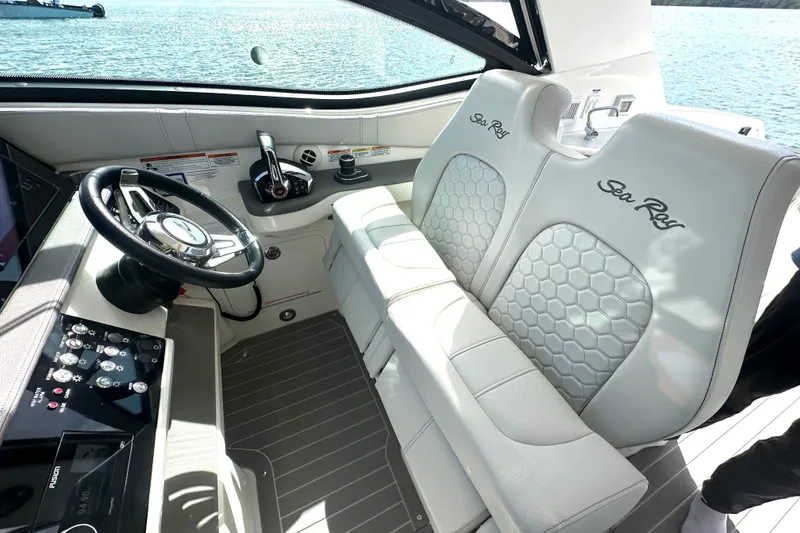 Slide: The Image of 2022 Sea Ray Sundancer 320 Outboard helm with luxurious seating and modern controls. - 34
