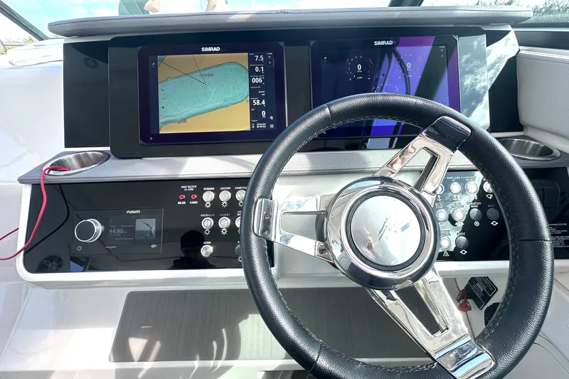 Slide: The Image of 2022 Sea Ray Sundancer 320 Outboard helm with advanced navigation displays and controls. - 36