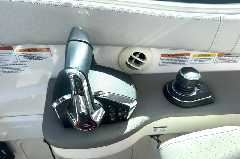 Slide: The Image of 2022 Sea Ray Sundancer 320 Outboard helm controls with throttle and joystick. - 37