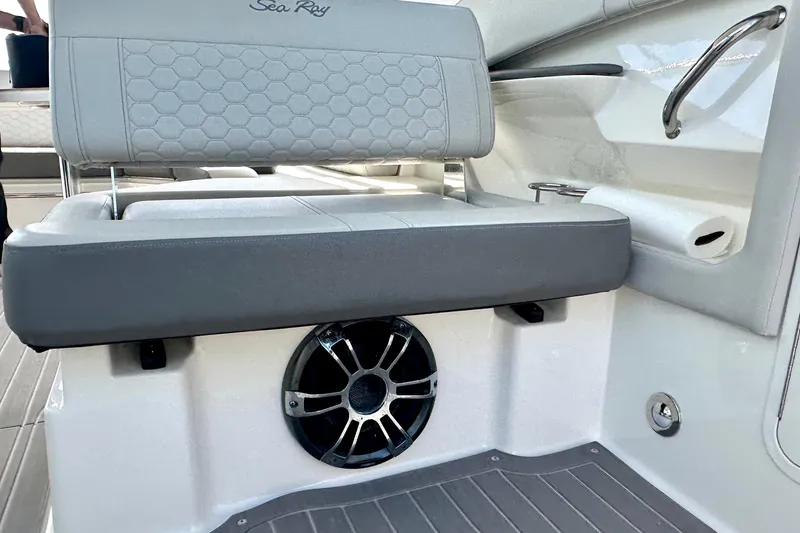 Slide: The Image of 2022 Sea Ray Sundancer 320 Outboard interior seating with speaker and handrail. - 40
