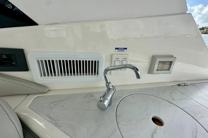 Slide: The Image of 2022 Sea Ray Sundancer 320 Outboard interior with sink and control panel. - 41