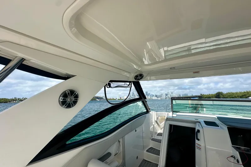 Slide: The Image of 2022 Sea Ray Sundancer 320 Outboard interior with city skyline view. - 45