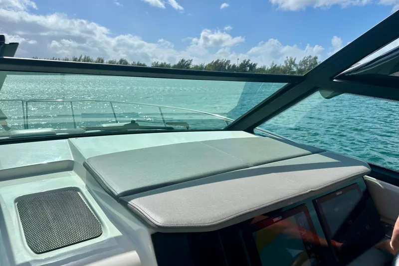 Slide: The Image of 2022 Sea Ray Sundancer 320 Outboard dashboard with scenic ocean view. - 46