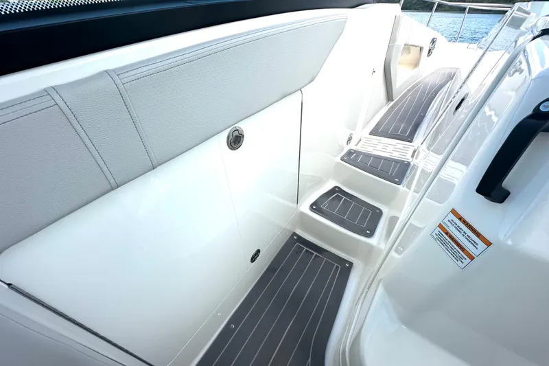 Slide: The Image of 2022 Sea Ray Sundancer 320 Outboard boat interior with sleek white seating and non-slip steps. - 48