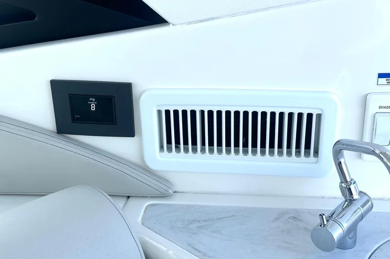 Slide: The Image of 2022 Sea Ray Sundancer 320 Outboard interior with air vent and control panel. - 54