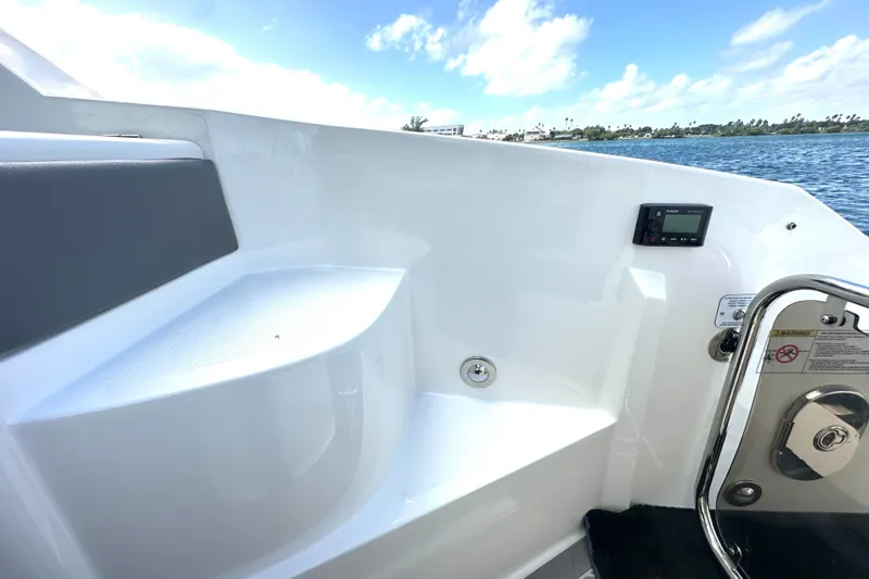 Slide: The Image of 2022 Sea Ray Sundancer 320 Outboard interior with seating and control panel, ocean view. - 55