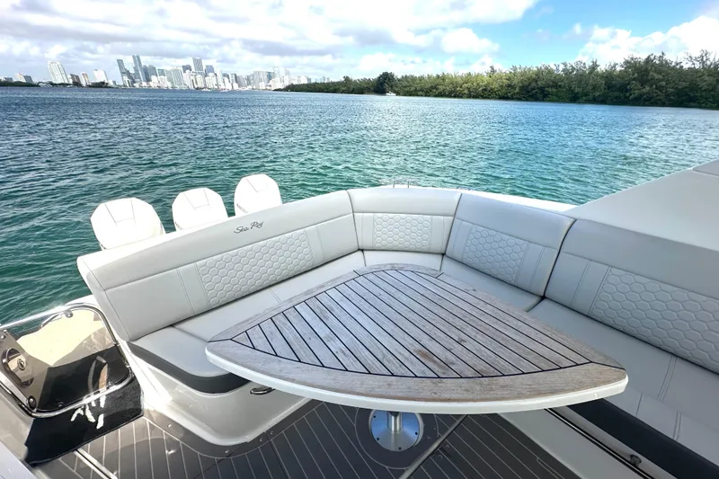Slide: The Image of Luxurious 2022 Sea Ray Sundancer 320 Outboard with elegant seating and scenic waterfront view. - 56