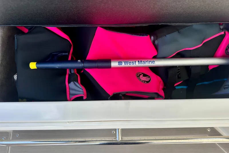 Slide: The Image of Storage compartment on 2022 Sea Ray Sundancer 320 Outboard with West Marine gear and life jackets. - 61