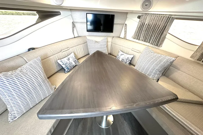 Slide: The Image of Interior of 2022 Sea Ray Sundancer 320 Outboard with elegant seating and table. - 66