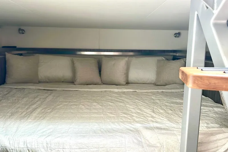 Slide: The Image of Interior cabin of 2022 Sea Ray Sundancer 320 Outboard with cozy bedding and pillows. - 71