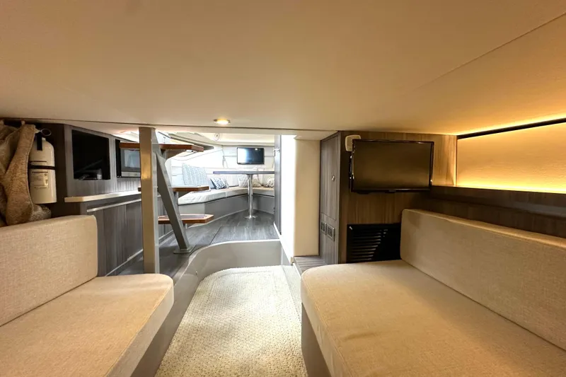 Slide: The Image of 2022 Sea Ray Sundancer 320 Outboard interior with modern seating and entertainment area. - 73