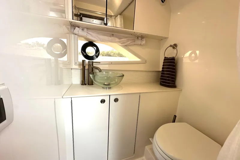 Slide: The Image of 2022 Sea Ray Sundancer 320 Outboard bathroom with modern sink and toilet. - 75