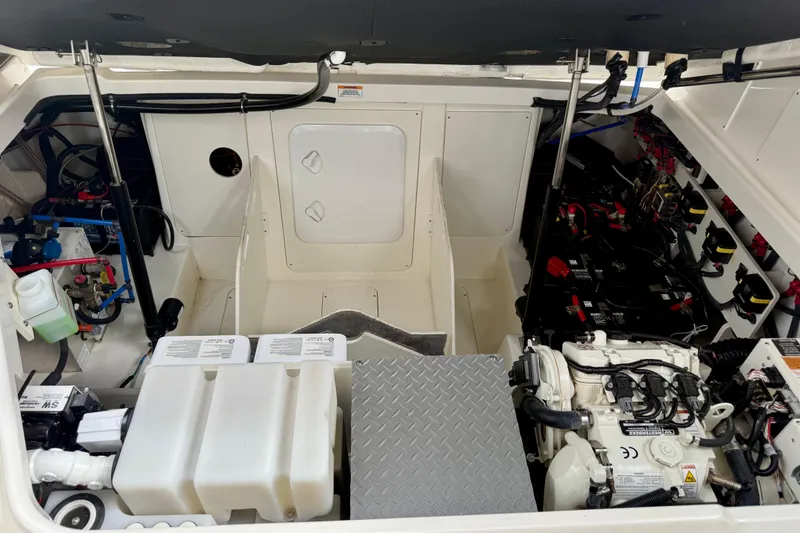 Slide: The Image of Engine compartment of 2022 Sea Ray Sundancer 320 Outboard, showcasing mechanical components and storage. - 78
