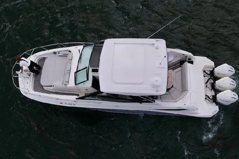 Slide: The Image of 2022 Sea Ray Sundancer 320 Outboard cruising on water, aerial view. - 8